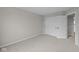 A cozy carpeted bedroom with neutral paint, a door, and a sliding closet door at 4205 Douro Trl, Westfield, IN 46062