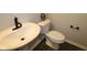 Clean half bathroom with a white sink, toilet, and modern fixtures at 4229 Douro Trl, Westfield, IN 46062