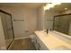 Modern bathroom features a glass shower, black hardware, neutral color scheme, and quartz countertops at 4229 Douro Trl, Westfield, IN 46062
