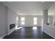 Bright living room featuring modern flooring, neutral walls, and a cozy fireplace at 4229 Douro Trl, Westfield, IN 46062