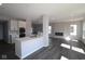 Open concept kitchen and living area with stainless appliances, island, and modern fireplace at 4229 Douro Trl, Westfield, IN 46062