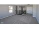 Open loft area with natural light, wrought iron banister, and neutral carpeting at 4229 Douro Trl, Westfield, IN 46062