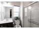 Clean bathroom with dark brown vanity, shower, and window at 453 Gathering Ln, Greenwood, IN 46143
