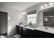 Elegant bathroom with dual vanity, dark brown cabinets and a shower at 453 Gathering Ln, Greenwood, IN 46143