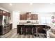 Modern kitchen with island, stainless steel appliances, and quartz countertops at 453 Gathering Ln, Greenwood, IN 46143
