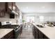 Open kitchen with stainless steel appliances and white countertops at 453 Gathering Ln, Greenwood, IN 46143