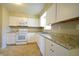 White kitchen with granite countertops and stainless steel appliances at 4575 Ayrshire St, Indianapolis, IN 46228