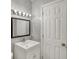 This bathroom has marble-look tiling, a bright vanity with a mirror, and a standard door at 4632 Normal Ave, Indianapolis, IN 46226