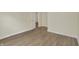 Neutral bedroom with wood-look flooring and an open door at 4632 Normal Ave, Indianapolis, IN 46226