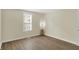 Bright bedroom with wood-look flooring, a window with blinds and neutral paint at 4632 Normal Ave, Indianapolis, IN 46226