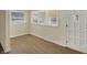 Bright entryway featuring wood-look flooring, neutral paint, and a multi-light white front door at 4632 Normal Ave, Indianapolis, IN 46226