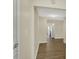 Bright hallway with hardwood floors leading to a modern, eat-in kitchen with stainless steel appliances at 4632 Normal Ave, Indianapolis, IN 46226