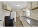 Well-lit kitchen featuring granite countertops, white cabinetry, and modern appliances at 4632 Normal Ave, Indianapolis, IN 46226