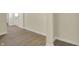 Neutral living area featuring wood-look floors and white trim at 4632 Normal Ave, Indianapolis, IN 46226