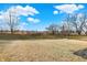 Open grassy backyard with mature trees at 6559 Seabiscuit Rd, Whitestown, IN 46075