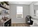 Home office with built-in shelving, a large window, and a workspace at 6559 Seabiscuit Rd, Whitestown, IN 46075