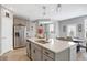 Modern kitchen with stainless steel refrigerator, white quartz countertops, and gray cabinets at 6559 Seabiscuit Rd, Whitestown, IN 46075