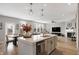 Open concept kitchen features a large island with white countertops and stainless steel appliances at 6559 Seabiscuit Rd, Whitestown, IN 46075