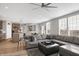 Open living space with a large sectional sofa and adjacent kitchen at 6559 Seabiscuit Rd, Whitestown, IN 46075