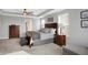 Main bedroom with king-size bed, wood furniture, and a ceiling fan at 6559 Seabiscuit Rd, Whitestown, IN 46075