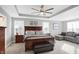 Spacious main bedroom with a king-size bed, plush carpet, and a seating area at 6559 Seabiscuit Rd, Whitestown, IN 46075