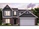 Two-story home with brick and siding exterior, two-car garage, and landscaping at 7320 Bailow Ln, McCordsville, IN 46055