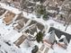 Aerial view of snow-covered homes with well-maintained lawns and driveways in a quiet residential neighborhood at 9519 Summer Ridge Pl, Indianapolis, IN 46260