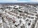 Aerial view of a residential community showcasing snow-covered houses and surrounding landscape with a road nearby at 9519 Summer Ridge Pl, Indianapolis, IN 46260