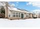 Backyard exterior view of the home covered in fresh snow featuring a patio door and windows at 9519 Summer Ridge Pl, Indianapolis, IN 46260