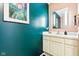 Stylish half-bath with trendy teal walls, white vanity, and decorative art at 9519 Summer Ridge Pl, Indianapolis, IN 46260