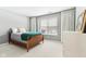 Cozy bedroom featuring a wood frame bed, neutral color walls, and a large window at 9519 Summer Ridge Pl, Indianapolis, IN 46260