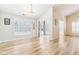 Bright dining room featuring hardwood floors, modern lighting, and access to a sunroom at 9519 Summer Ridge Pl, Indianapolis, IN 46260