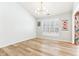 Bright dining room with modern lighting, hardwood floors, and large window with shutters at 9519 Summer Ridge Pl, Indianapolis, IN 46260