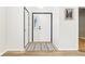 Bright foyer with hardwood floors, white walls, and a stylish entry rug at 9519 Summer Ridge Pl, Indianapolis, IN 46260
