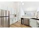 Modern kitchen with stainless steel appliances, white countertops, and light-green cabinets for a fresh, airy feel at 9519 Summer Ridge Pl, Indianapolis, IN 46260