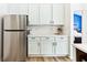 Kitchen featuring stainless appliances, white countertops, and sleek, light-green cabinetry at 9519 Summer Ridge Pl, Indianapolis, IN 46260