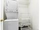 Functional laundry area with stacked washer and dryer, plus added storage at 9519 Summer Ridge Pl, Indianapolis, IN 46260