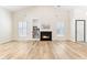 Inviting living room featuring hardwood floors, fireplace, and plenty of natural light at 9519 Summer Ridge Pl, Indianapolis, IN 46260