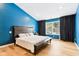 Spacious main bedroom with bright blue walls, dark curtains, and a cozy queen bed at 9519 Summer Ridge Pl, Indianapolis, IN 46260