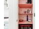 Charming pink pantry shelves, adorned with strawberry decor, plus a red microwave at 9519 Summer Ridge Pl, Indianapolis, IN 46260