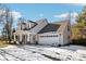 Beige vinyl sided home with a white garage door and a covered front porch at 10322 Sage Ct, Noblesville, IN 46060