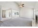 Open living room with vaulted ceiling, fireplace and neutral carpeting at 10322 Sage Ct, Noblesville, IN 46060