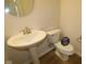 Elegant half-bath featuring a pedestal sink and modern fixtures, offering a stylish and convenient space for guests at 1144 Ridgevine Rd, Greenwood, IN 46143