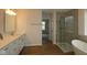 Luxurious bathroom with a glass-enclosed shower, soaking tub, and double sink vanity, creating a spa-like experience at 1144 Ridgevine Rd, Greenwood, IN 46143