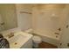 The bathroom features a white vanity, toilet, and shower-tub with bright lighting at 1144 Ridgevine Rd, Greenwood, IN 46143