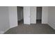 Spacious bedroom with neutral walls, carpet, and multiple doorways, perfect for flexible living at 1144 Ridgevine Rd, Greenwood, IN 46143