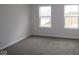 The bedroom is bright with natural light and features neutral walls and plush carpeting at 1144 Ridgevine Rd, Greenwood, IN 46143