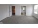 Spacious bedroom with neutral carpet and multiple doorways, providing a serene and versatile retreat at 1144 Ridgevine Rd, Greenwood, IN 46143