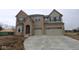 Two-story brick home with a two-car garage and concrete driveway, still under construction at 1144 Ridgevine Rd, Greenwood, IN 46143