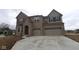 Beautiful two-story brick home featuring a three-car garage, offering a blend of style and functionality at 1144 Ridgevine Rd, Greenwood, IN 46143